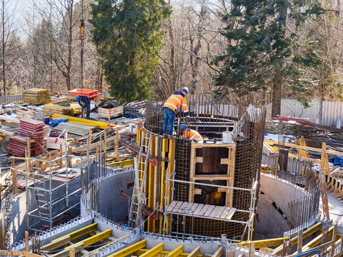 Construction Site of a Round Concrete Structure in a Forest Setting