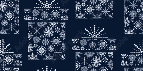 Elegant seamless pattern of white snowflakes shaped like gift boxes on dark blue background. Perfect for textile prints, holiday wrapping, and festive designs