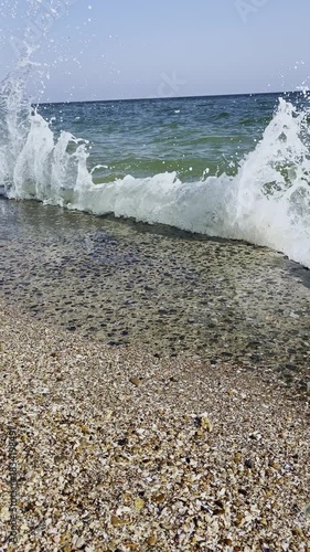  Gentle waves on a shelly beach on a sunny day
