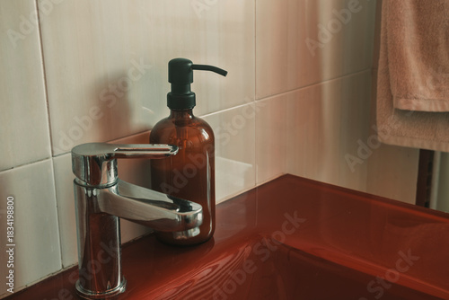 Brown pump bottle next to faucet in the bathroom for wash soap. Mockup product for design template.