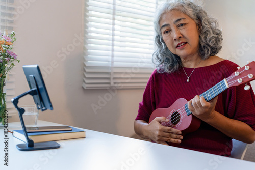 Senior Woman Using Tablet For learning Instrument
