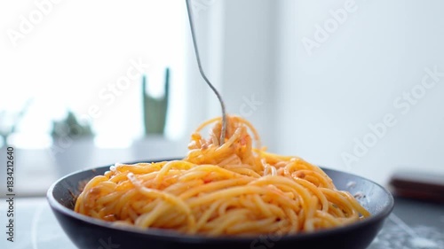 Close-up shot the fork picking delicious spaghetti