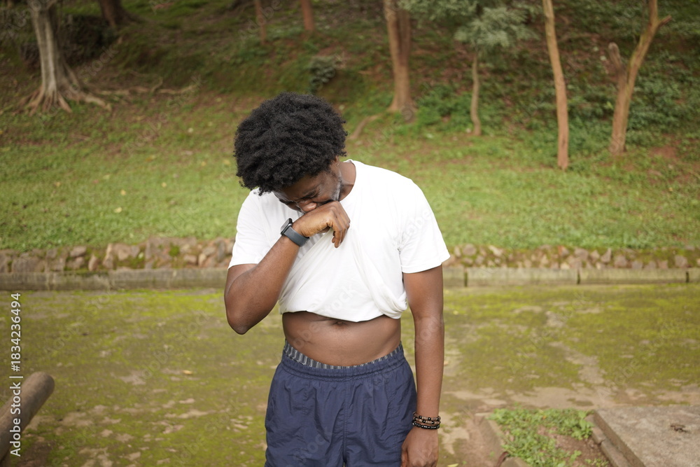 Naklejka premium A lone African man exercising in the park