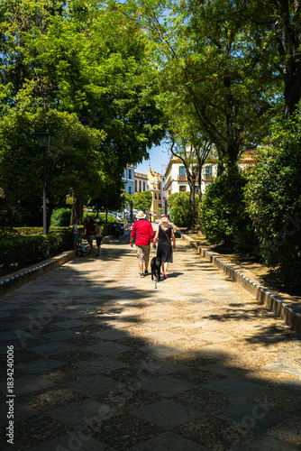 Mature couple strolling hand in hand in medieval city of seville spain