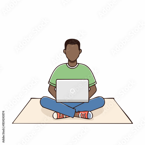 Young Man Sitting Cross Legged On A Mat With A Laptop In Front Of Him Wearing A Green T Shirt And Blue Jeans