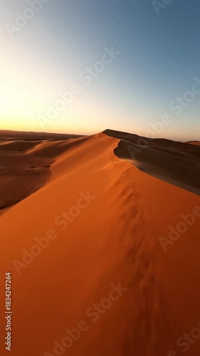 Desert Dunes at Sunset: An expansive view of desert dunes under a warm sunset glow. Sand reflects the last light of the day, creating stunning shadows and tones.