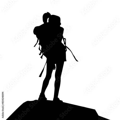 Woman standing on peak silhouette