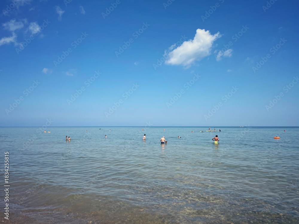 Fototapeta premium People swimming on a summer day in the Great Lakes