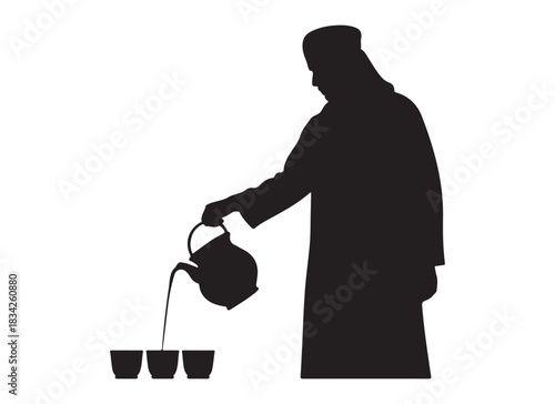  Silhouette of a person in traditional clothing pouring tea into small cups