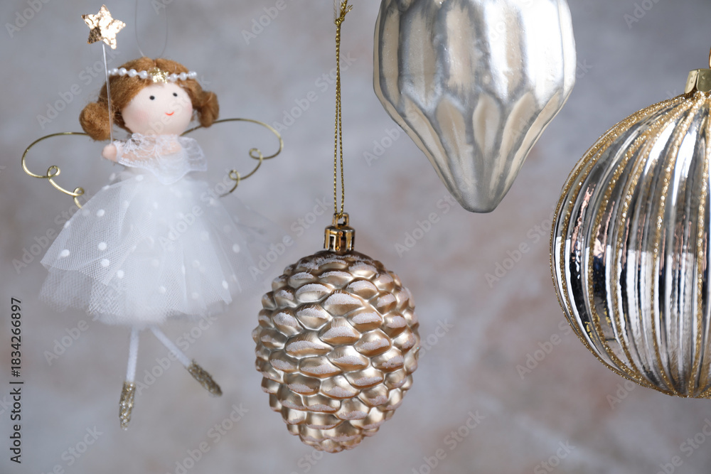 Obraz premium Beautiful Christmas decor hanging near light grey wall, closeup