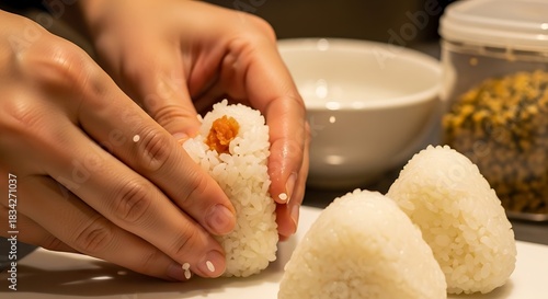 Fototapeta Naklejka Na Ścianę i Meble -  Preparing Onigiri, Japanese Rice Balls with Savory Filling and Human Touch