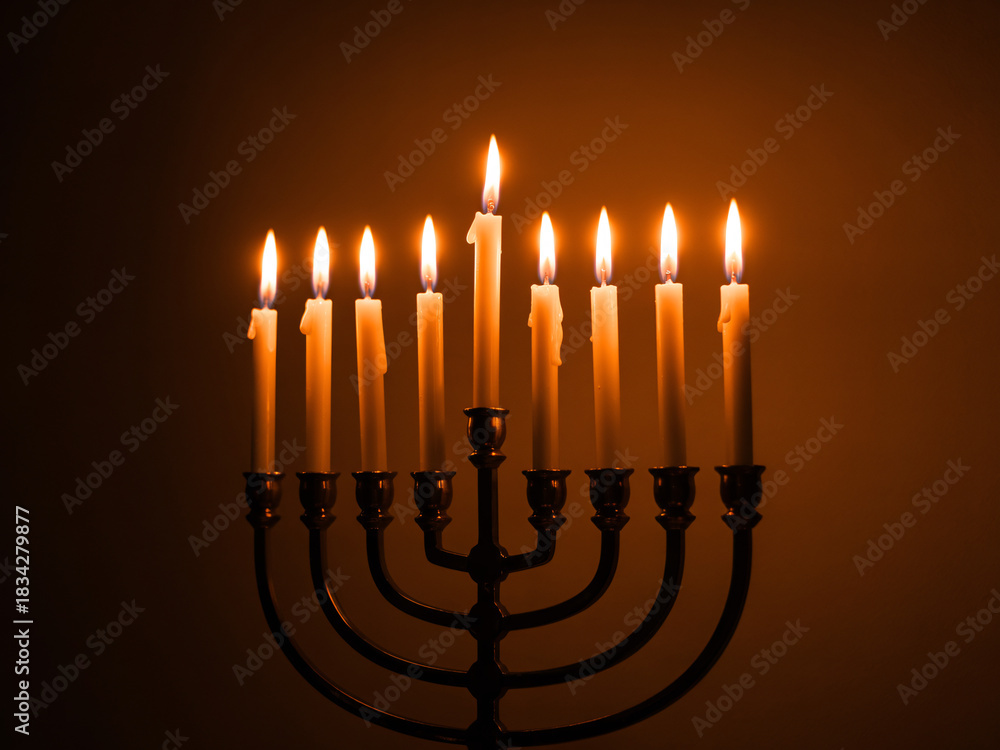 Fototapeta premium Illuminating Hanukkah with glowing candles, embrace traditions and celebrate the festival of lights with this warm holiday scene, evoking hope and joy