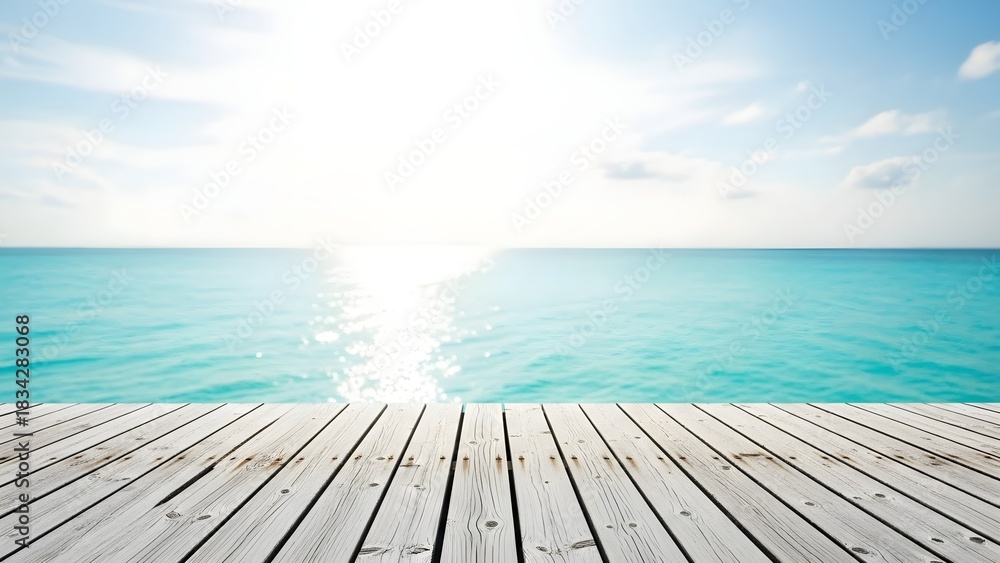 Fototapeta premium Wooden deck overlooking turquoise ocean with bright sunlight and blue sky