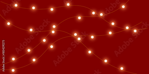 Warm white glowing fairy lights strung across a deep red festive background.