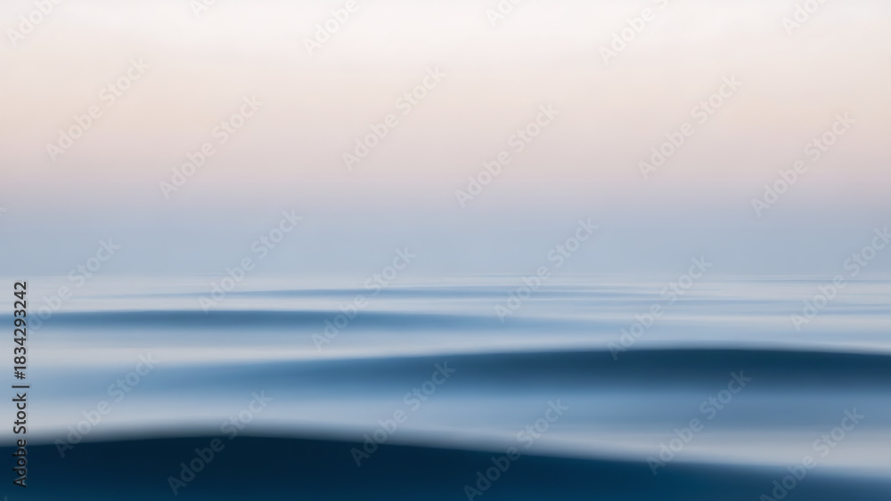Obraz premium Abstract, minimalist long exposure of calm ocean waves at sunset. Soft pastel colors and blurred motion create a serene, dreamy, and tranquil seascape, ideal for backgrounds and design.