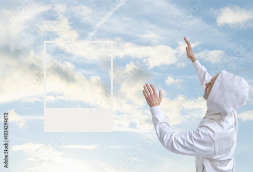 man in white hoodie reaching up towards cloudy sky, cloud dancer, arms outstretched, spiritual connection with nature, ivory pearl wallpaper or digital background for design and product presentation