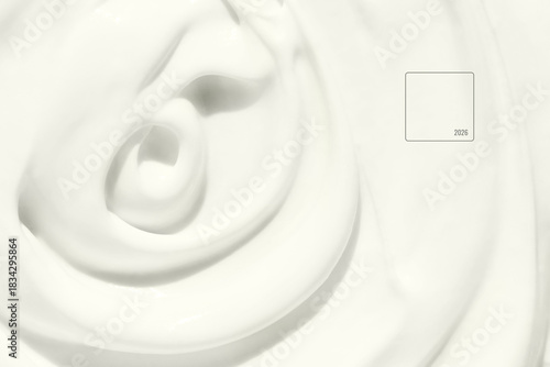 Smooth swirling white cream texture in close up creating a soft minimal background with gentle curves and glossy surface suitable for skincare beauty wellness and cosmetic themes. Cream