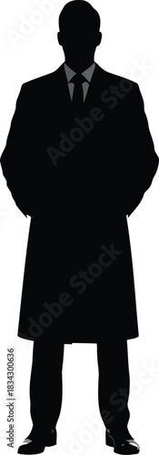 Silhouette of a man in a trench coat and tie standing