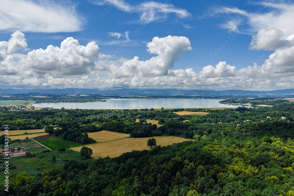 Obraz premium Aerial drone view of Nyskie Lake and protected nature reserve shoreline in Opole region Poland, tranquil water surface, natural wetlands, green forests and scenic landscape