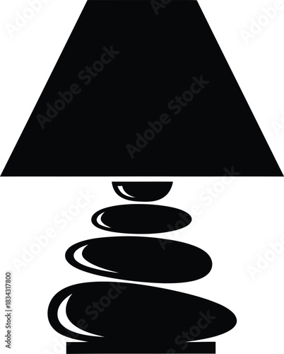 Zen inspired table lamp with stacked stones as a base and a black conical shade