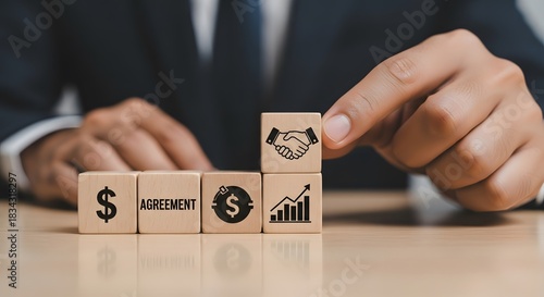 Signing business agreement for financial growth on wooden cubes