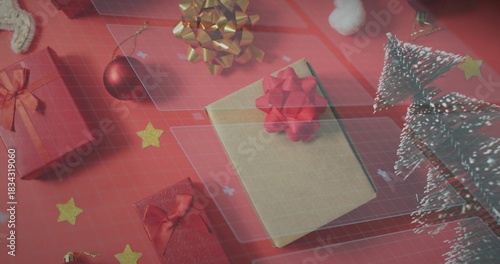 Displaying kraft-paper gift box resting on red surface, with red bows, gold bow, snowy trees