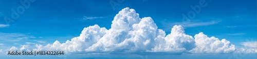 A beautiful sunny sky filled with fluffy white clouds against a deep blue backdrop.