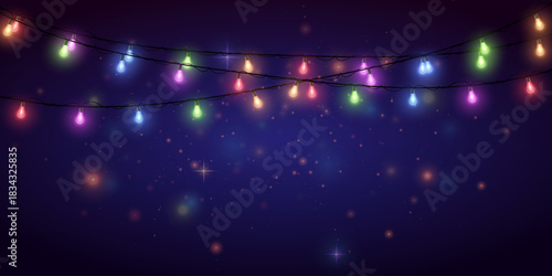 Colorful festoon string lights glowing against dusk sky.