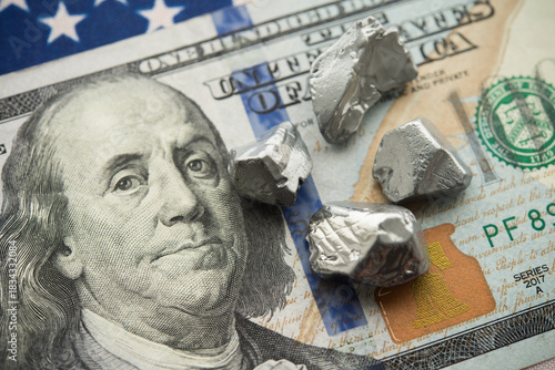 Rare earth element on US dollar bill banknote, American flag background. US vs China chip war, tech war, semiconductor industry concept. China curbs on exports of rare germanium and gallium to USA.