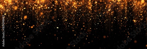 Golden sparkling bokeh on black background - glittering abstract light particles