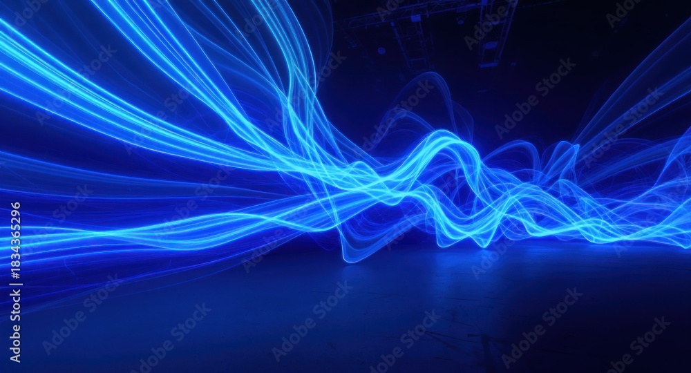 Obraz premium Blue flowing energy, with luminous trails against a dark backdrop