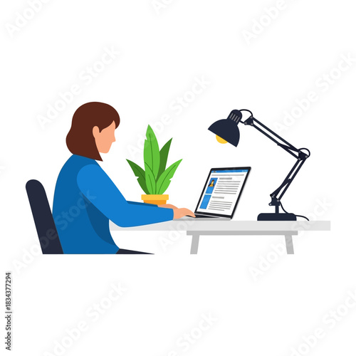 Woman working on laptop at desk in home office environment.
