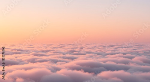 The soft, first light of the sun touching the clouds.