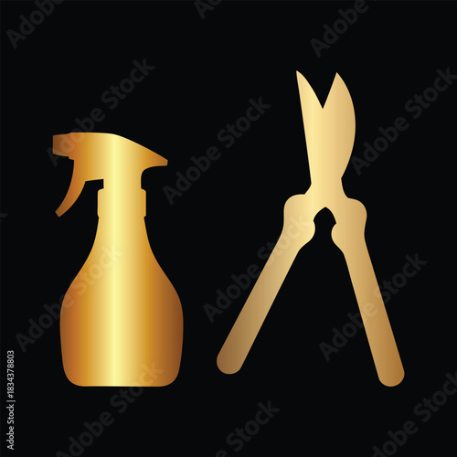 Golden spray bottle and pruning shears on black background Keywords: spray bottle, gardening