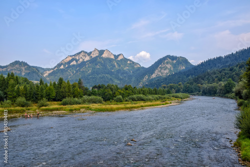 Fototapeta Naklejka Na Ścianę i Meble -  Dunajec river - popular tourist spot for boat rafting - in Pieniny National Park., Poland at sunny day. Trzy Korony (Three Crowns) summit in the background