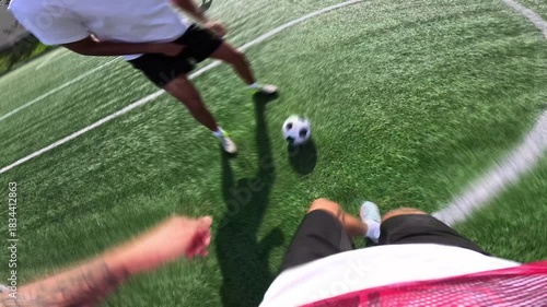First person perspective of a professional football player dribbling the ball, shooting a penalty kick, and celebrating scoring a goal