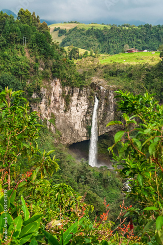 Waterfall in the middle of a canyon in the Colombian Andes. With lush vegetation and vivid colors of real nature. Los Molinos waterfall, Villamaría Caldas