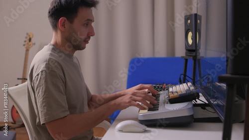 Music producer manipulates faders and displays in dimly lit home studio, Creative audio engineer calibrates channel strips and meters during detailed mixing session
