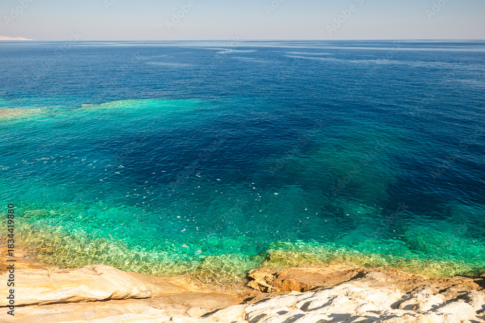 Obraz premium Rocky granodiorite coastline and clear turquoise water of the greek island of Serifos in the Cyclades