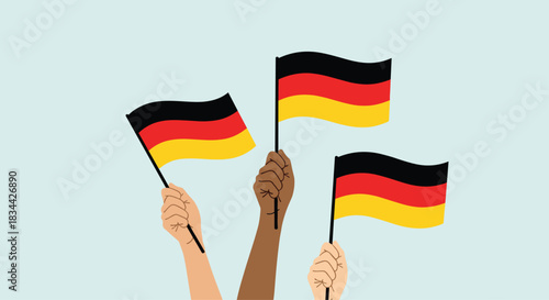 Diverse hands wave German flags in a display of unity and celebration, representing multiculturalism and national pride in Germany.