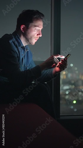 analyzing urgent message by window, night analyst focused on important alert with city glow background