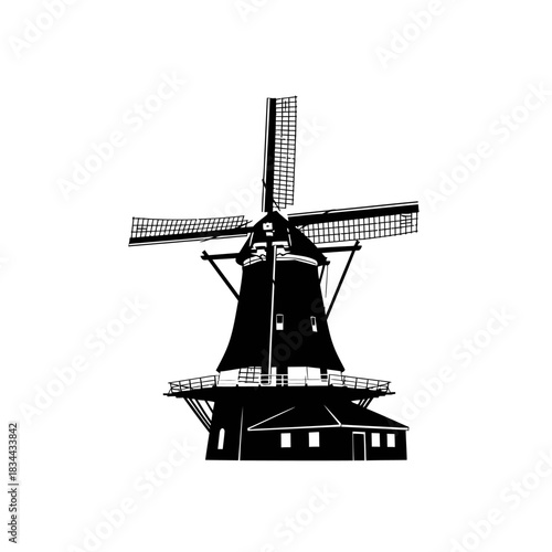 Silhouette of a traditional dutch windmill with four blades rotating isolated on white background