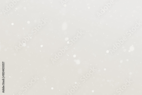 Soft beige snowfall background with gentle light dots for a peaceful winter mood Demonstration Color of the Year 2026