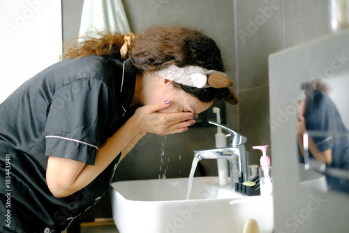 Woman washing face during morning skincare routine