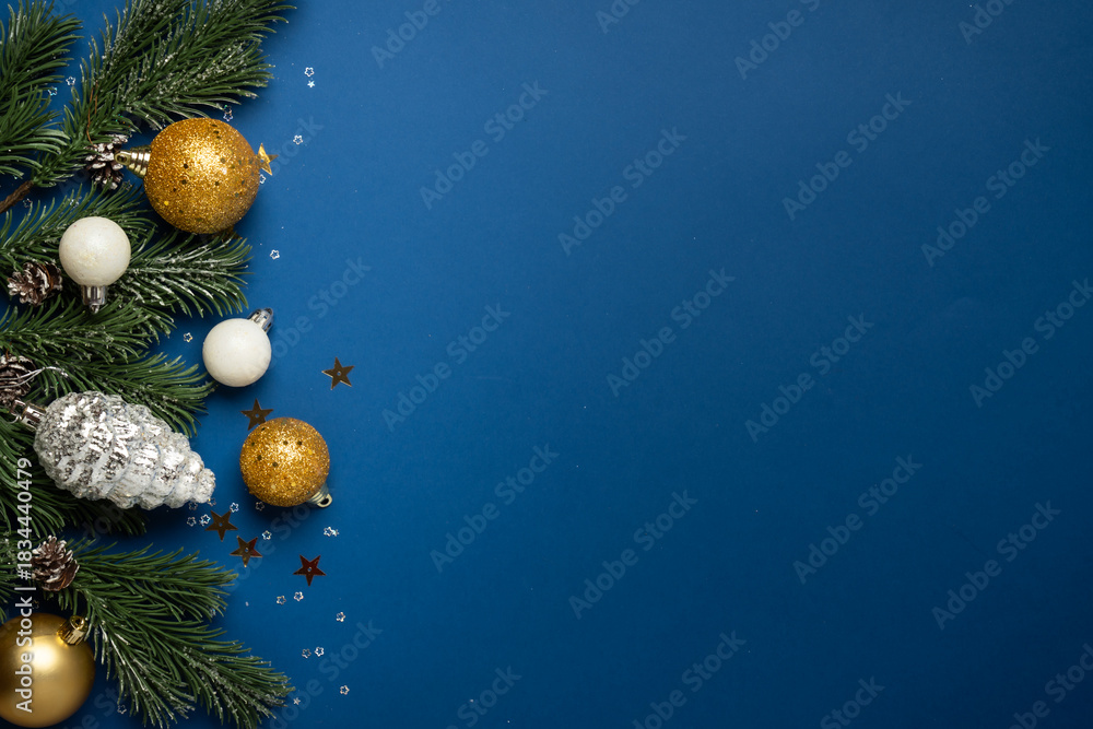 Naklejka premium White and golden Christmas decorations and gift box on navy background.
