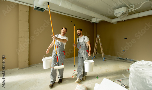 Two painters cheerfully wor...