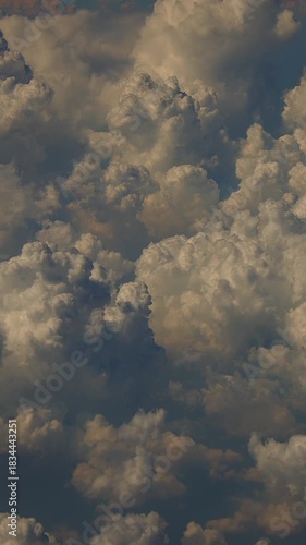 aerial perspective showcasing warm late sunlight illuminating textured cloud layers and casting gentle shadows