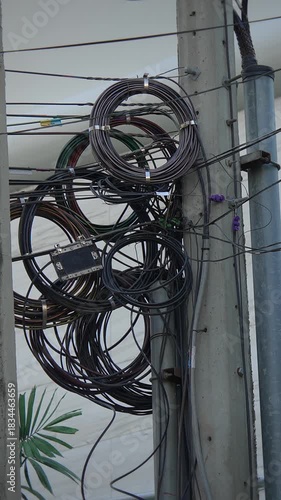 compact loops adorn city utility pole, close view of organized cables and utility fixtures