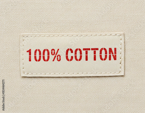 100 Cotton Fabric Label with Red Text on Textile Background