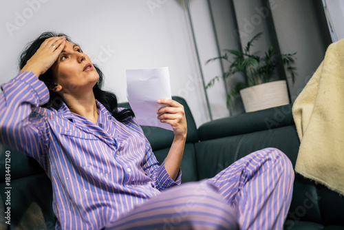Middle-aged woman cooling herself during hot flash